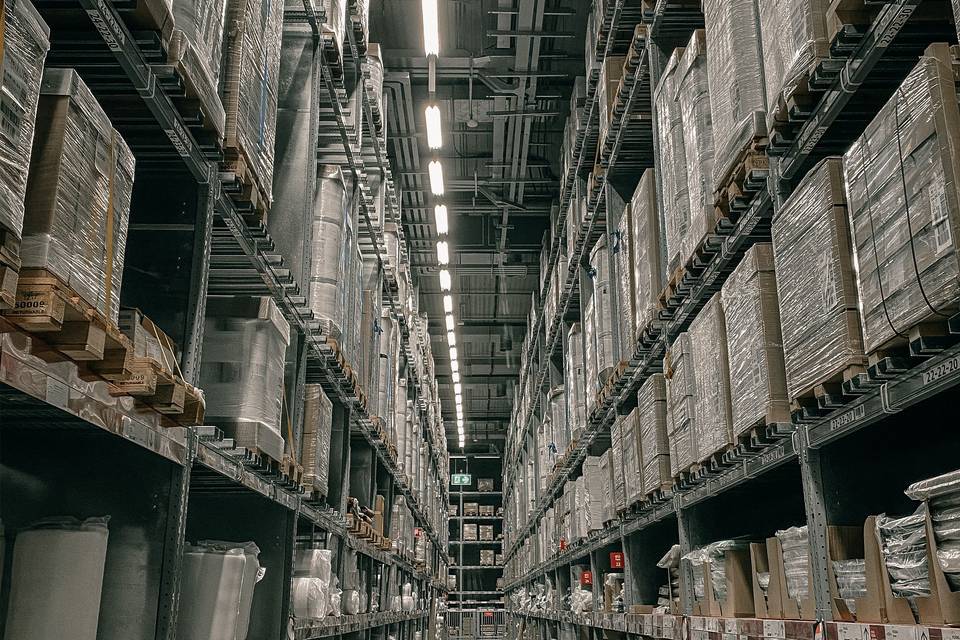 Racked and palletised goods lining a warehouse aisle